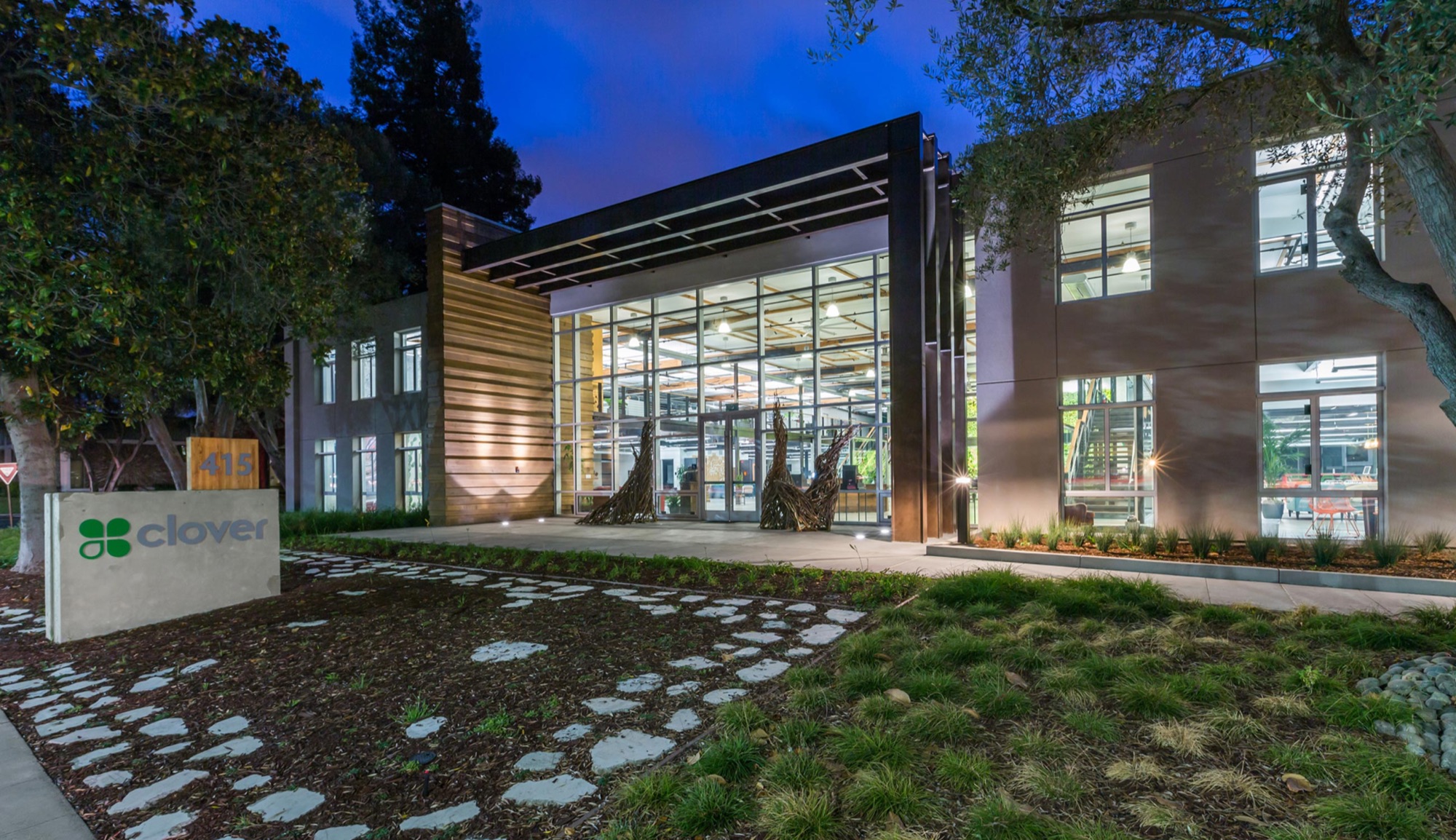 415 Mathilda in Sunnyvale at dusk. Glass entry, wood screen, the lights on inside.